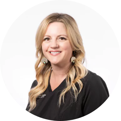 Smiling female dental team member with blonde hair in a black Premier Choice Dental Center uniform.