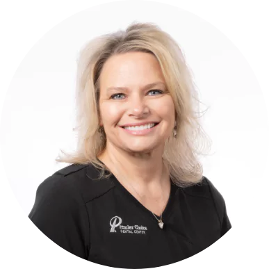 Smiling female team member at Premier Choice Dental Center in a black uniform.