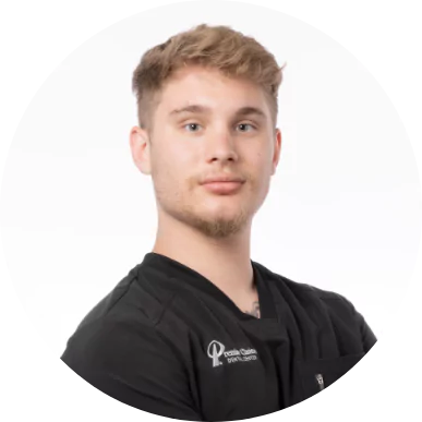 Male dental assistant at Premier Choice Dental Center wearing a black uniform.