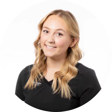 Smiling female dental assistant at Premier Choice Dental Center wearing a black uniform.